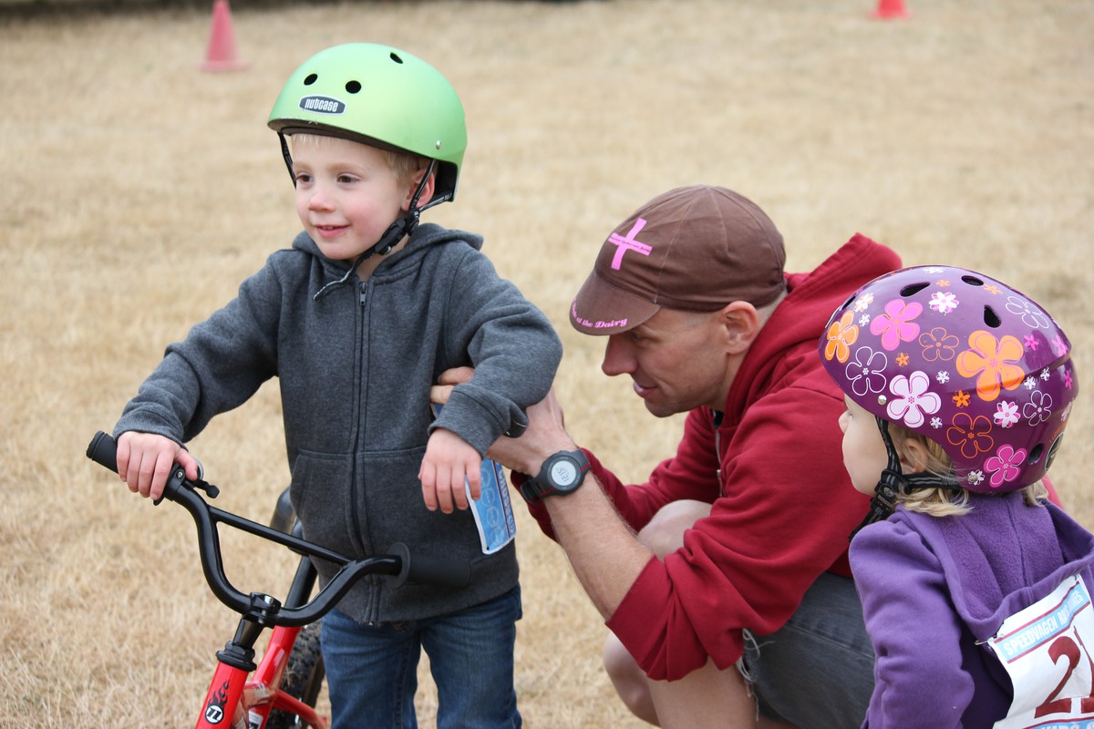 Paul pinning a race number on Orion while Iris watches, 2012