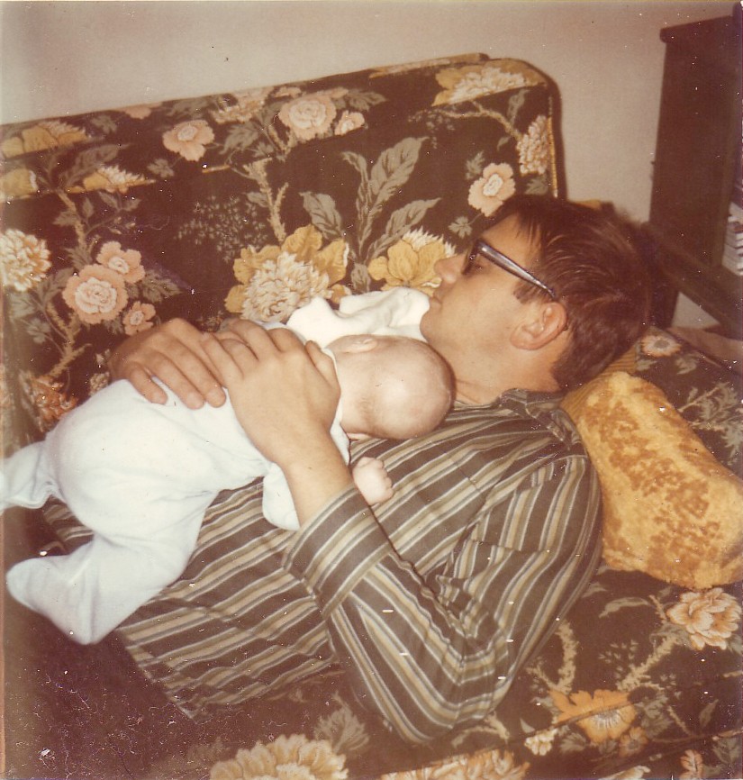 Scan of a photo from 1971. A man — my father — napping on a couch, with an infant — myself — asleep on his chest