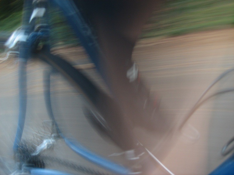 Motion blur: a foot pedaling a steel road racing bicycle