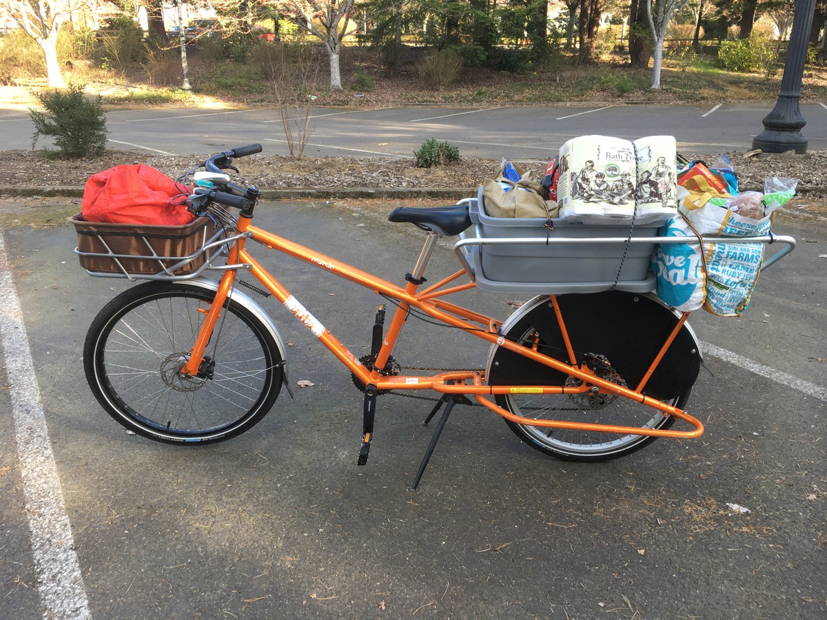 Longtail cargo bike loaded with bags of groceries