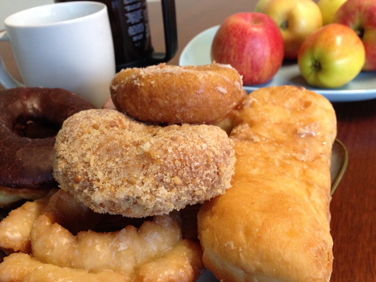 Closeup of donuts, apples, and coffee