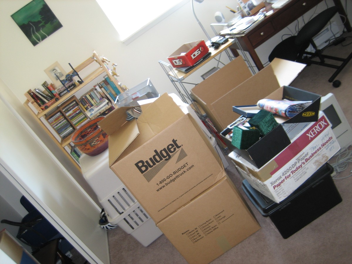 Dutch angle, interior, an office with several half-packed moving boxes