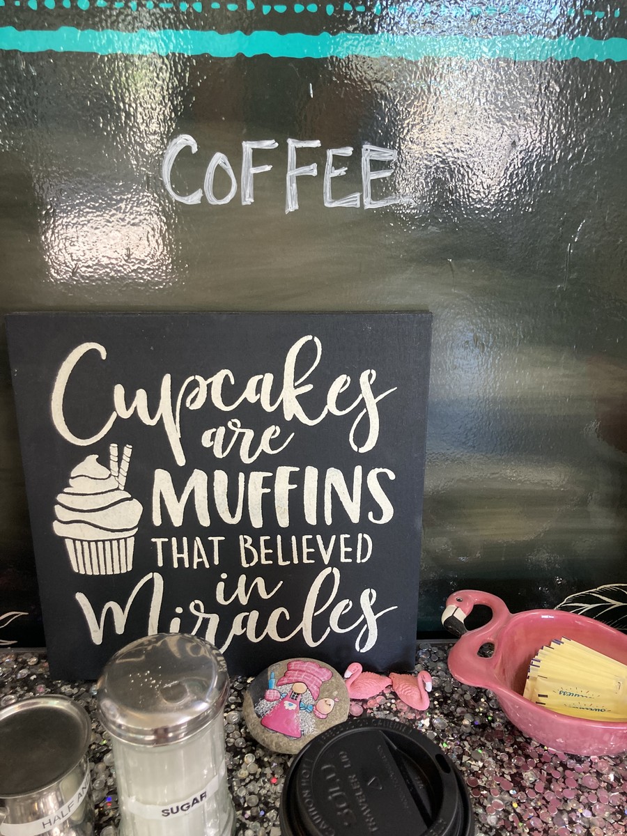 Sign at a small town bakery reading “Cupcakes are Muffins that believed in miracles”