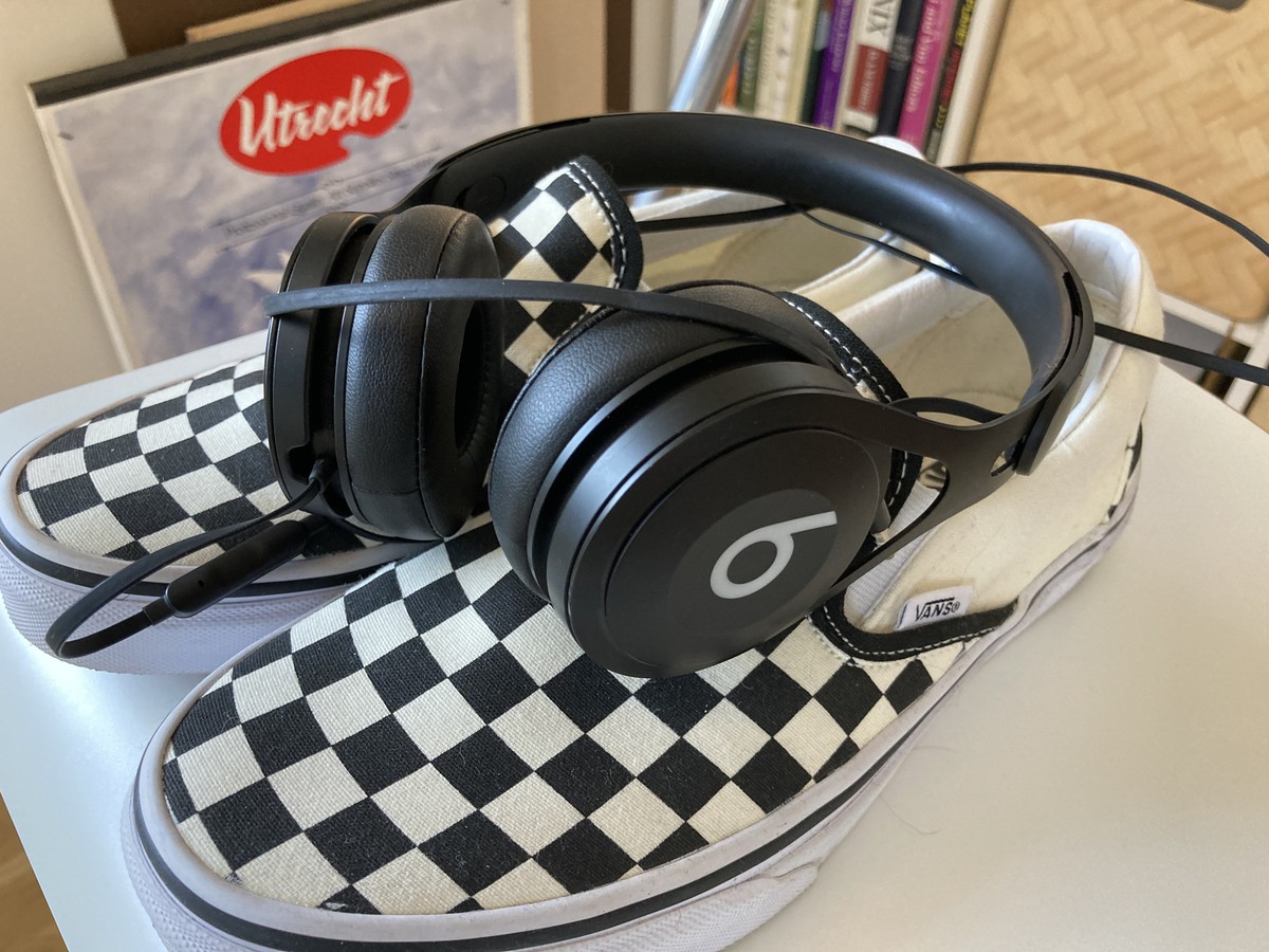 Closeup of headphones and a clean pair of Vans
