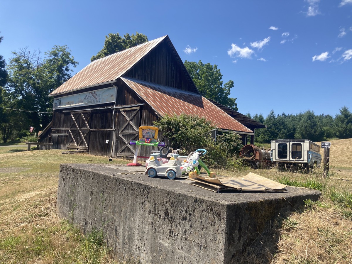 Sun-faded toys next to a rusty steel barn on Dorland Road