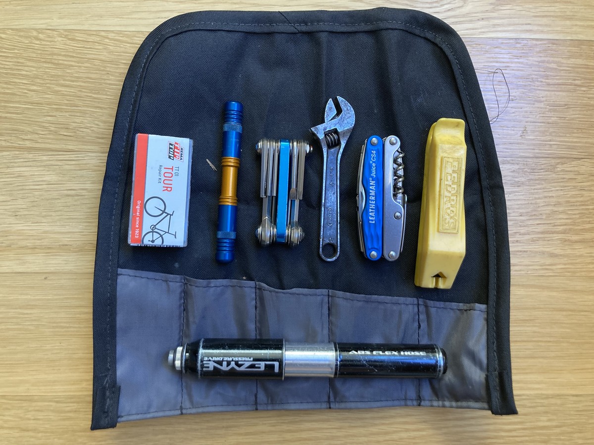 Closeup of a tool roll with bicycle tools spread on top of it