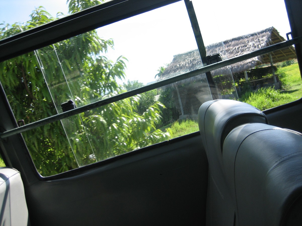 Photo taken out the window of a half-empty bus in Bali