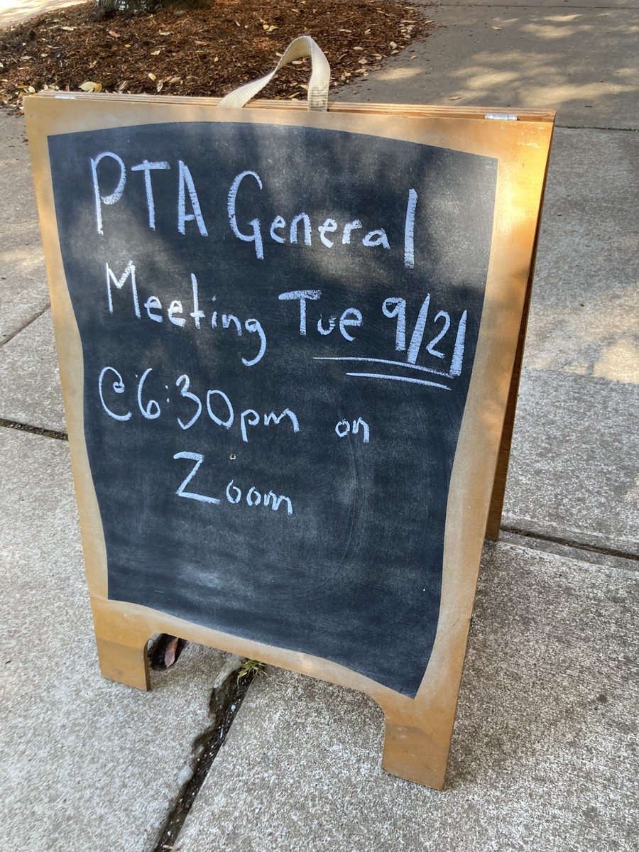 Breadboard on a sidewalk, reads: “PTA General Meeting Tue 9/21 @6:30pm on Zoom”