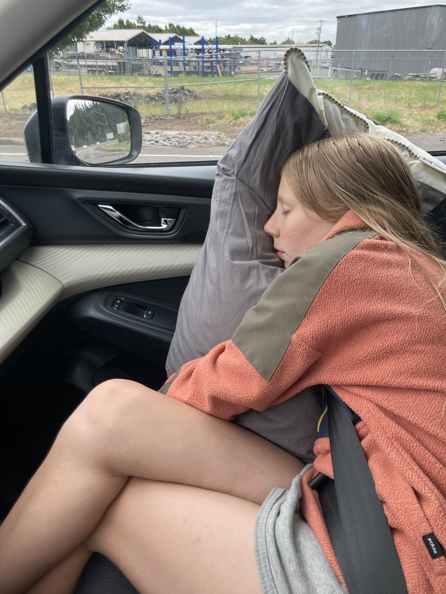 Ada asleep in the car on the way to Bend, June 2025