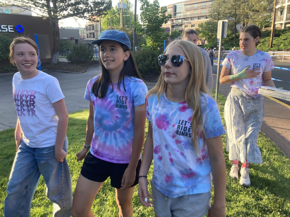 VALKYR juniors in casual team wear post-race, watching the pros