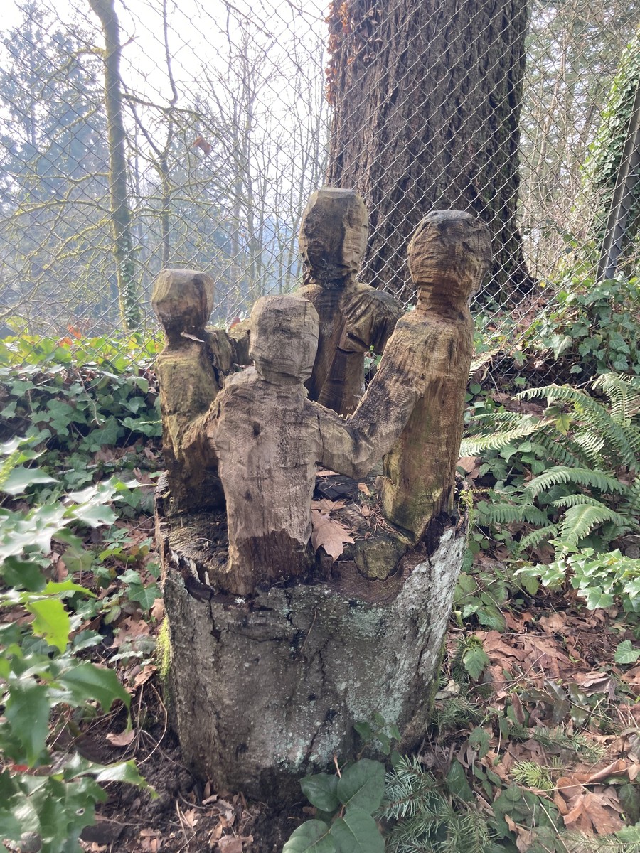 Figures carved from a tree stump in the Hillsdale neighborhood