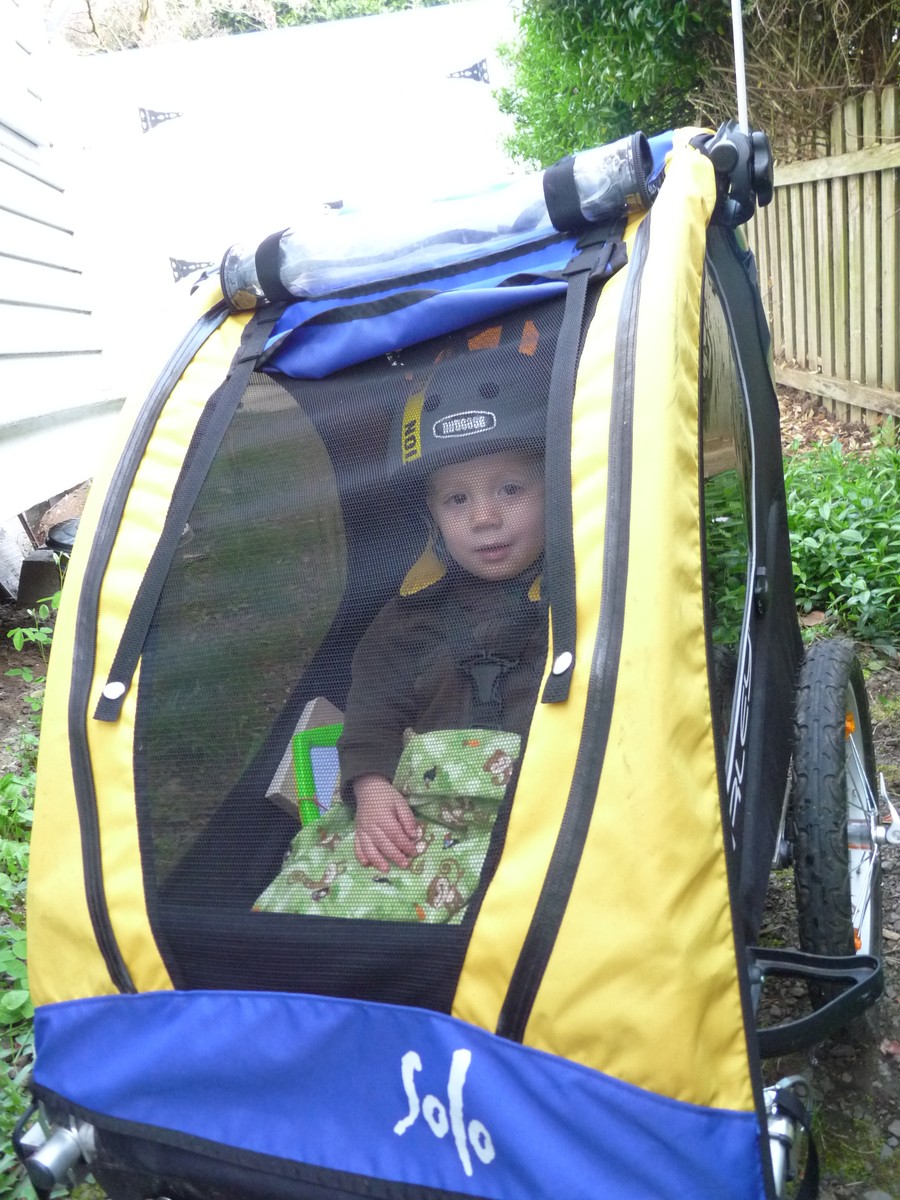 Preschool age kid in a Burley trailer on his way to preschool
