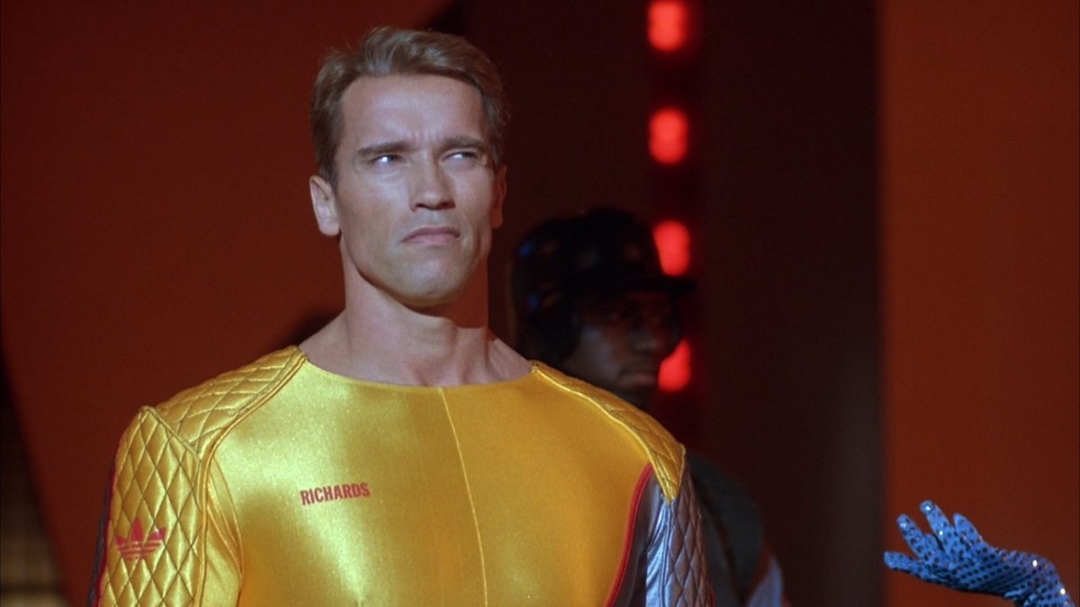 Still from RUNNING MAN with Arnold Schwarzenegger in a gold jumpsuit