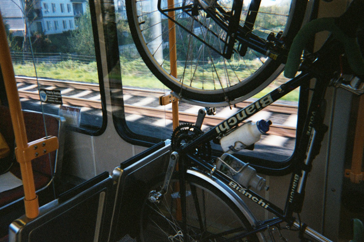 Bianchi bicycle hanging from a hook on a Max light rail train