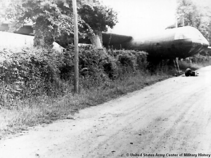 Historic photo of a cargo glider crashed in a hedge in Normandy. © United States Army Center of Military History