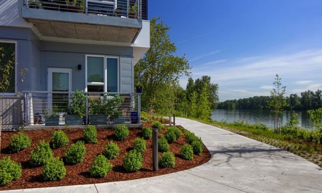 Paved ground-level path running around a nice apartment building