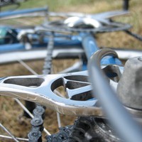 Extreme closeup of the dropouts of a bicycle, with a custom “V” stamped or cut into them