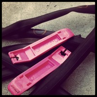 Closeup of two tire levers and a much-patched inner tube