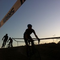 Bicycls racers in silhouette at sunset