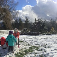 Kids building a snow person at Pittock Mansion