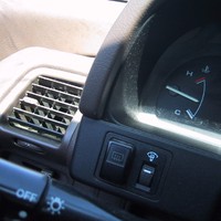 Closeup of part of a car’s control panel, the engine temperate gauge is the only notable item, it is almost exactly halfway between Cold and Hot