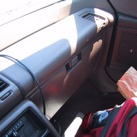 Backpack and fast food bag on the floor of a car