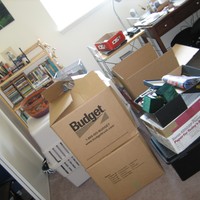 Dutch angle, interior, an office with several half-packed moving boxes