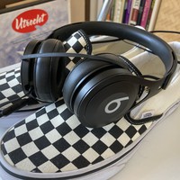 Closeup of headphones and a clean pair of Vans