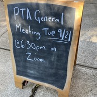 Breadboard on a sidewalk, reads: “PTA General Meeting Tue 9/21 @6:30pm on Zoom”