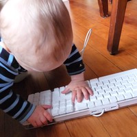 Orion as a baby playing with a computer keyboard