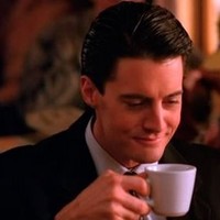 Screenshot from Twin Peaks of Agent Dale Cooper drinking coffee